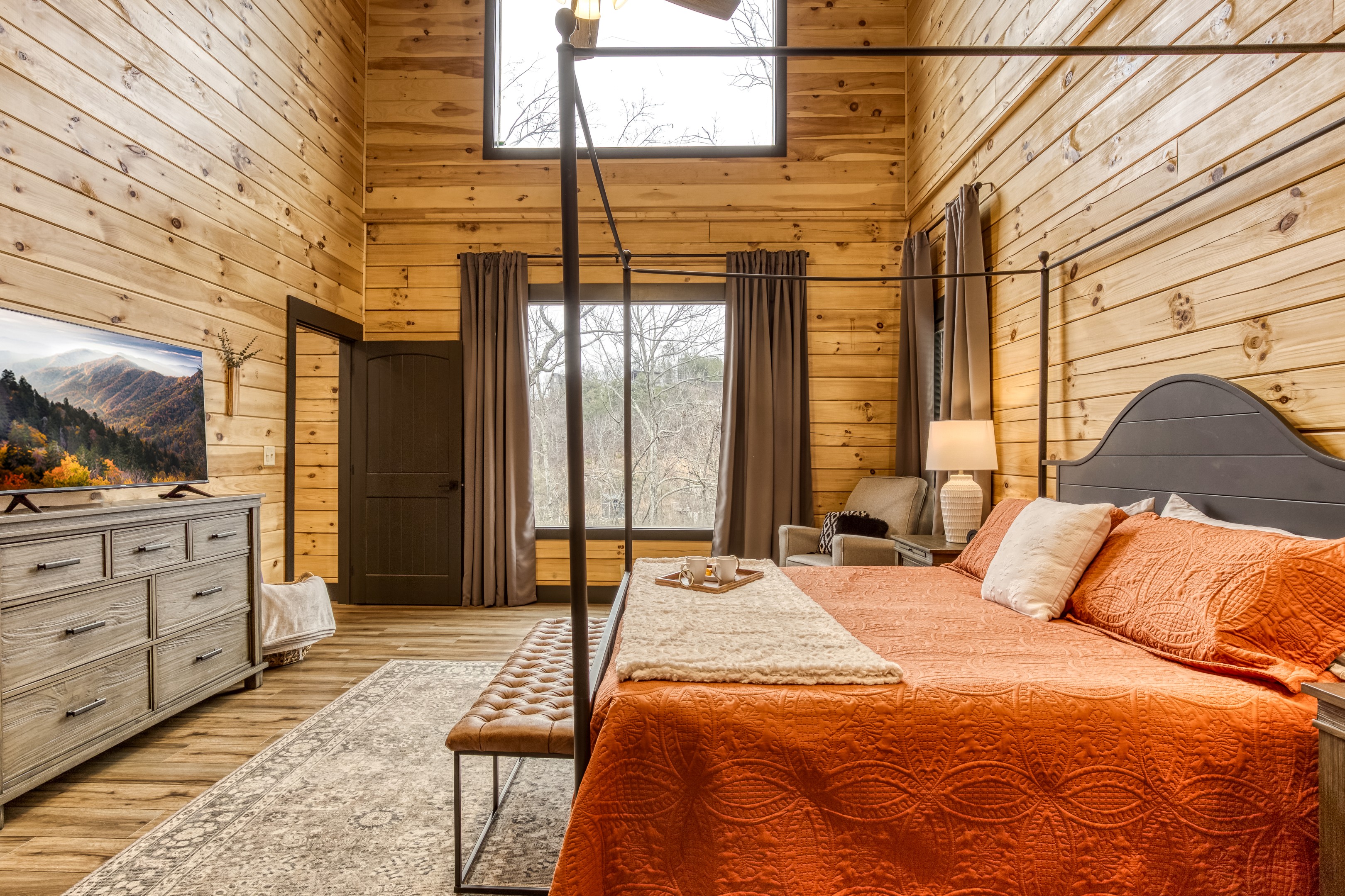A peaceful bedroom retreat with natural light and calming forest views to start and end your day