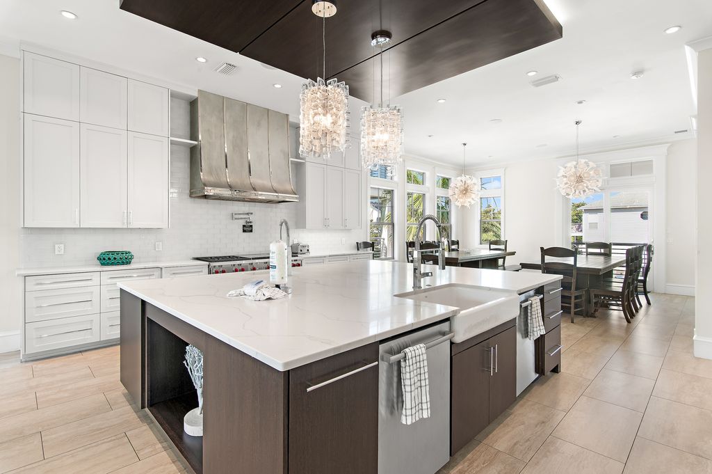 Fully equipped kitchen with large double-sided kitchen island for meal prep.