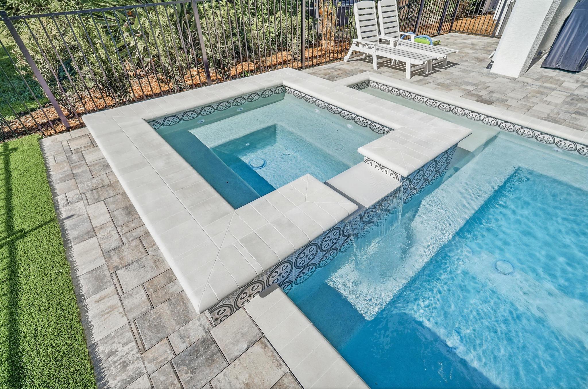 Sink into the bubbling spa while the spillway whispers into the pool, then stretch out on the loungers with a cold drink and zero agenda—your own private courtyard retreat for lazy afternoons and starry-night soaks.
