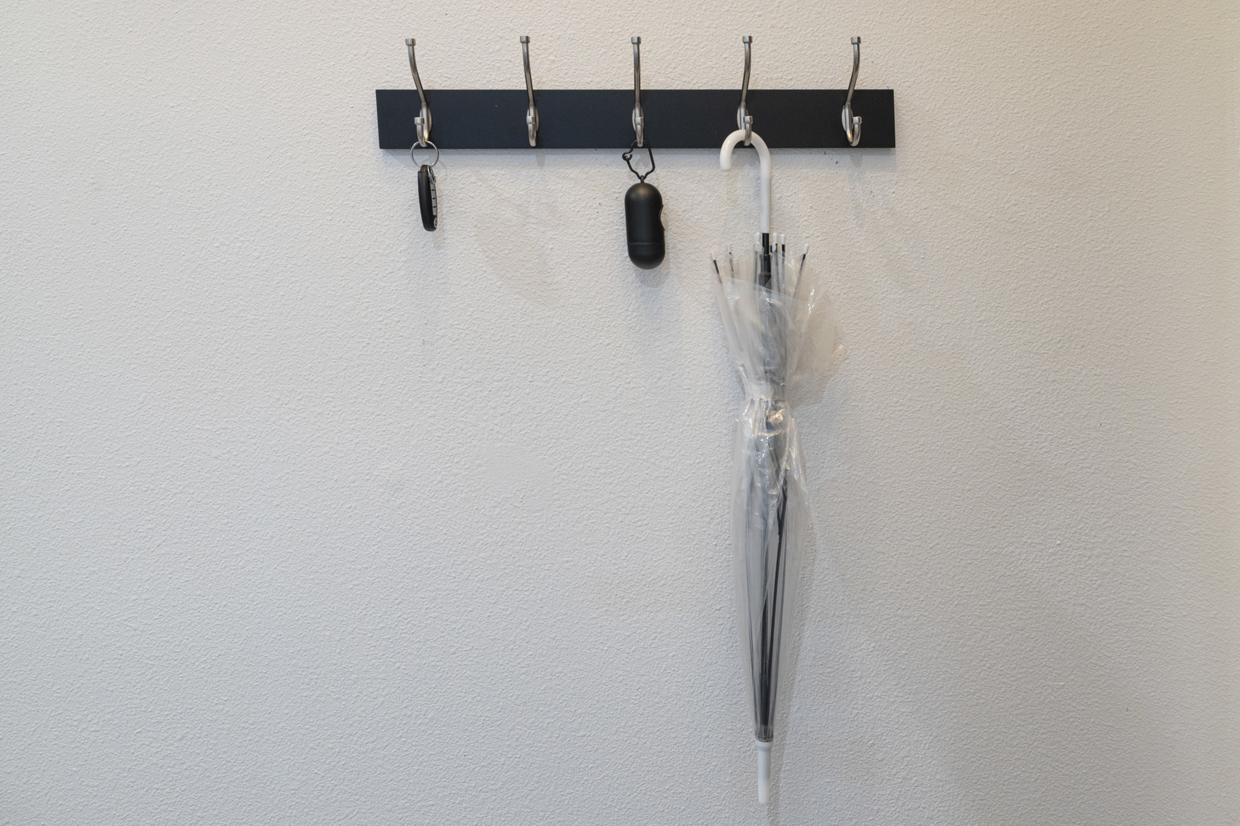 Modern hooks for your essentials, including an umbrella for unexpected Austin showers!