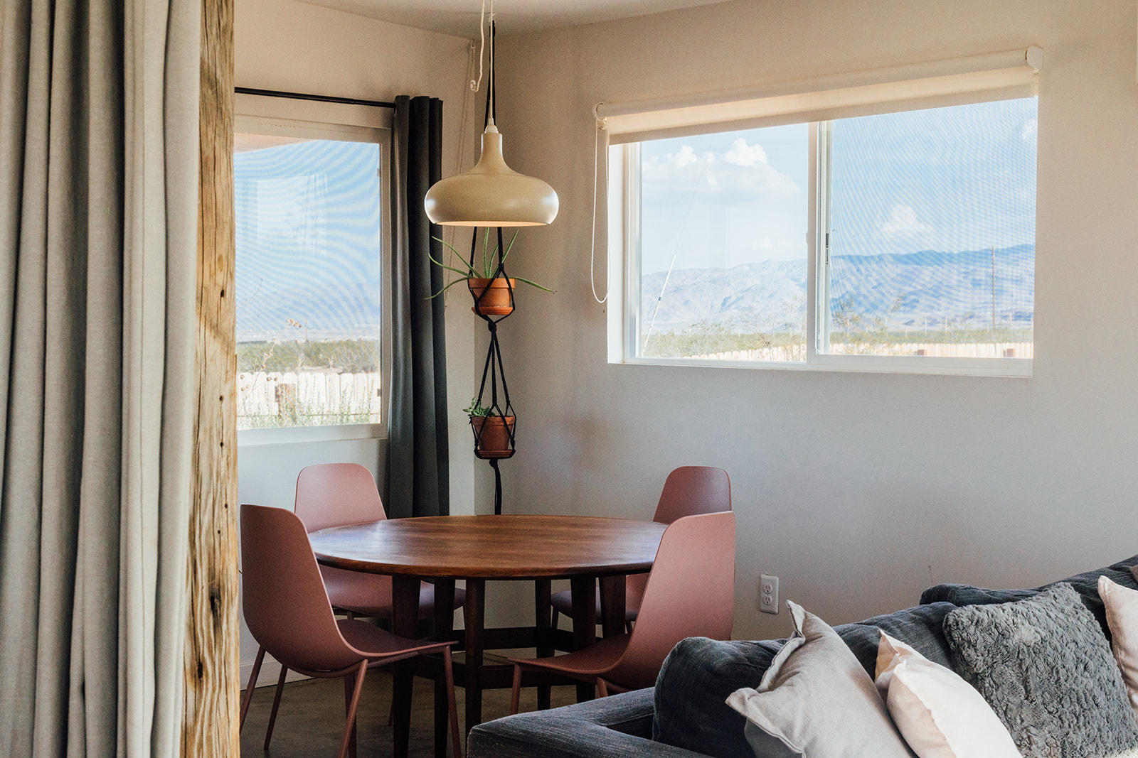 Bright dining area with modern table and chairs, warm natural light, and desert views — perfect for enjoying meals together.