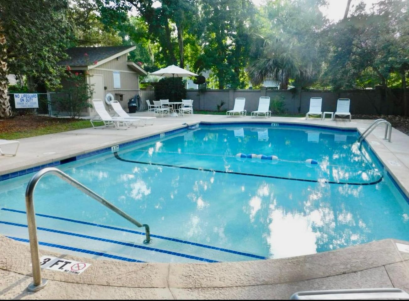 Community pool with lounge chairs