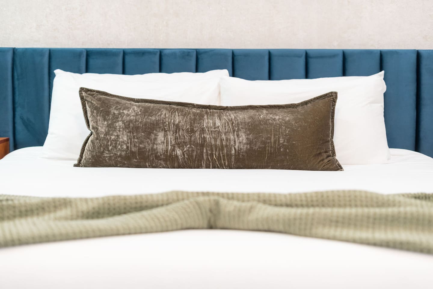 Close-up of the cozy bedding and accent pillow for restful nights.