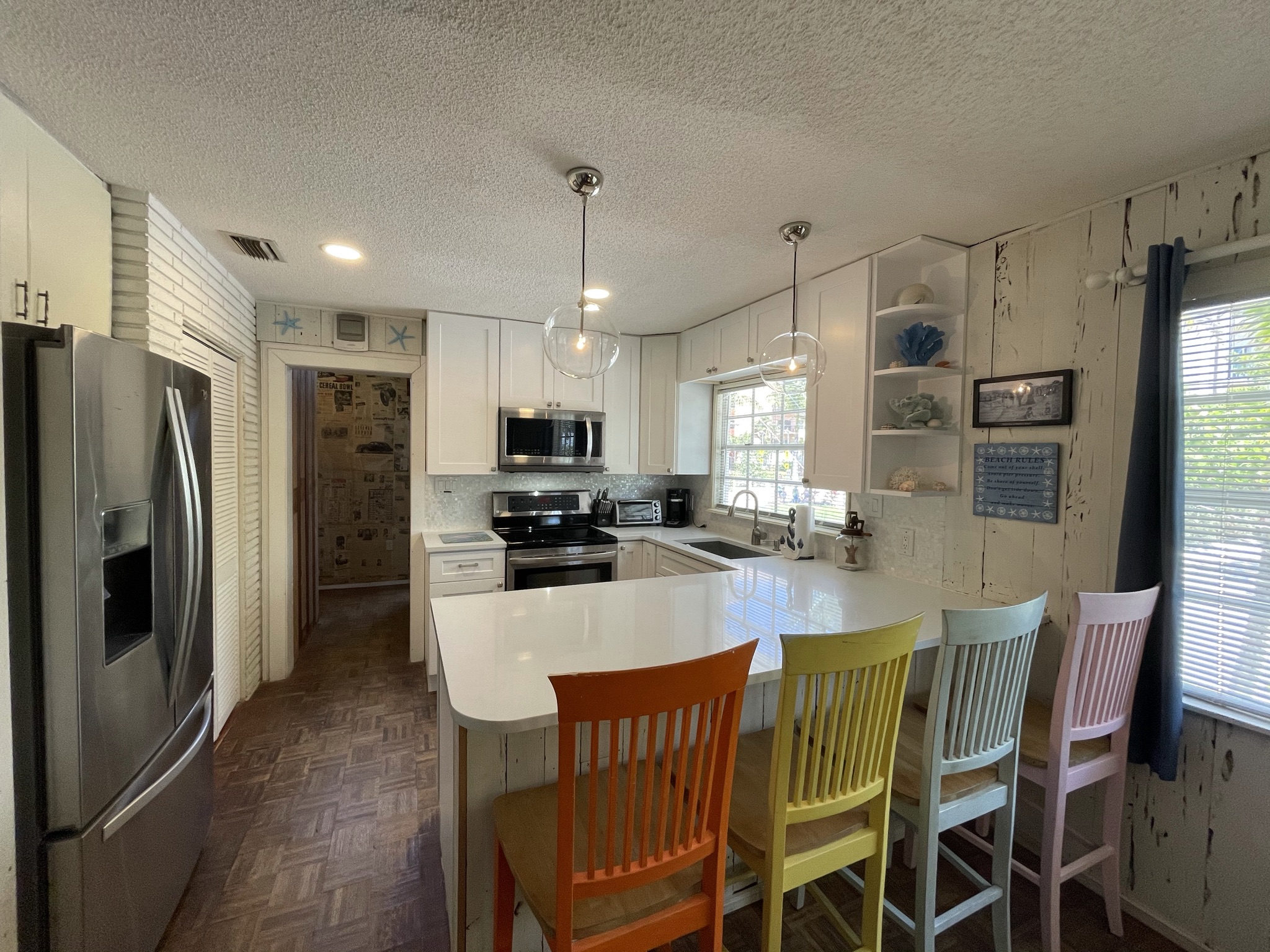 Open concept kitchen and breakfast bar,  Quartz Counter Tops, Mother of Pearl Backsplash, Restoration Hardware Pendant Lights