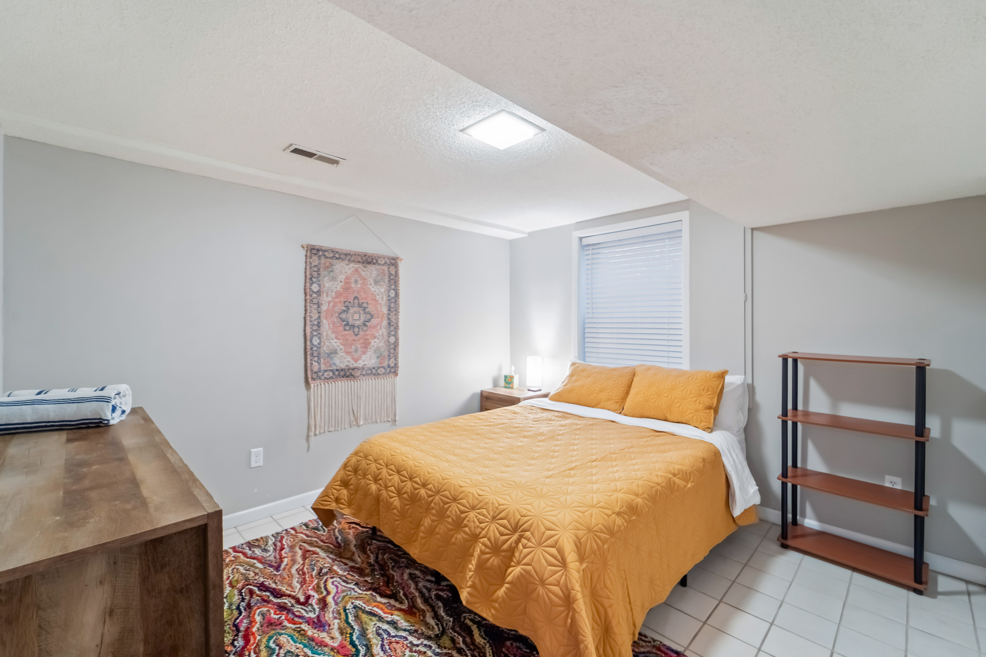 The second bedroom downstairs has everything you would need, a queen bed, 6 drawer dresser, large closet and nightstand with a reading light. 