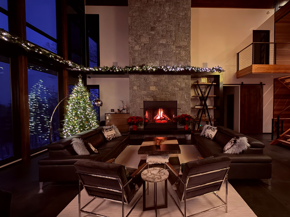Living room fireplace with Christmas lights at Sunset Falls &mdash; Berkshires