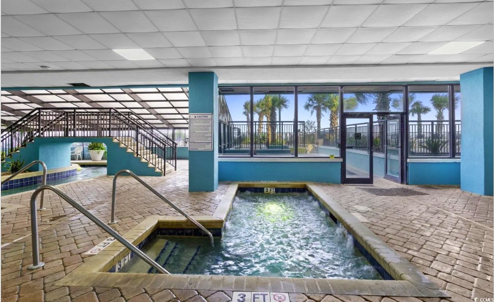 Behold the breathtaking view, where the azure waters of the pool seamlessly blend with the vast expanse of the ocean, creating a true seaside paradise.