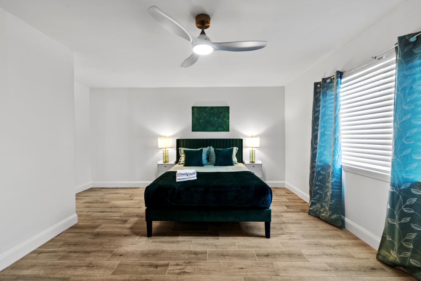 Serene master suite with luxurious bedding and tasteful decor.