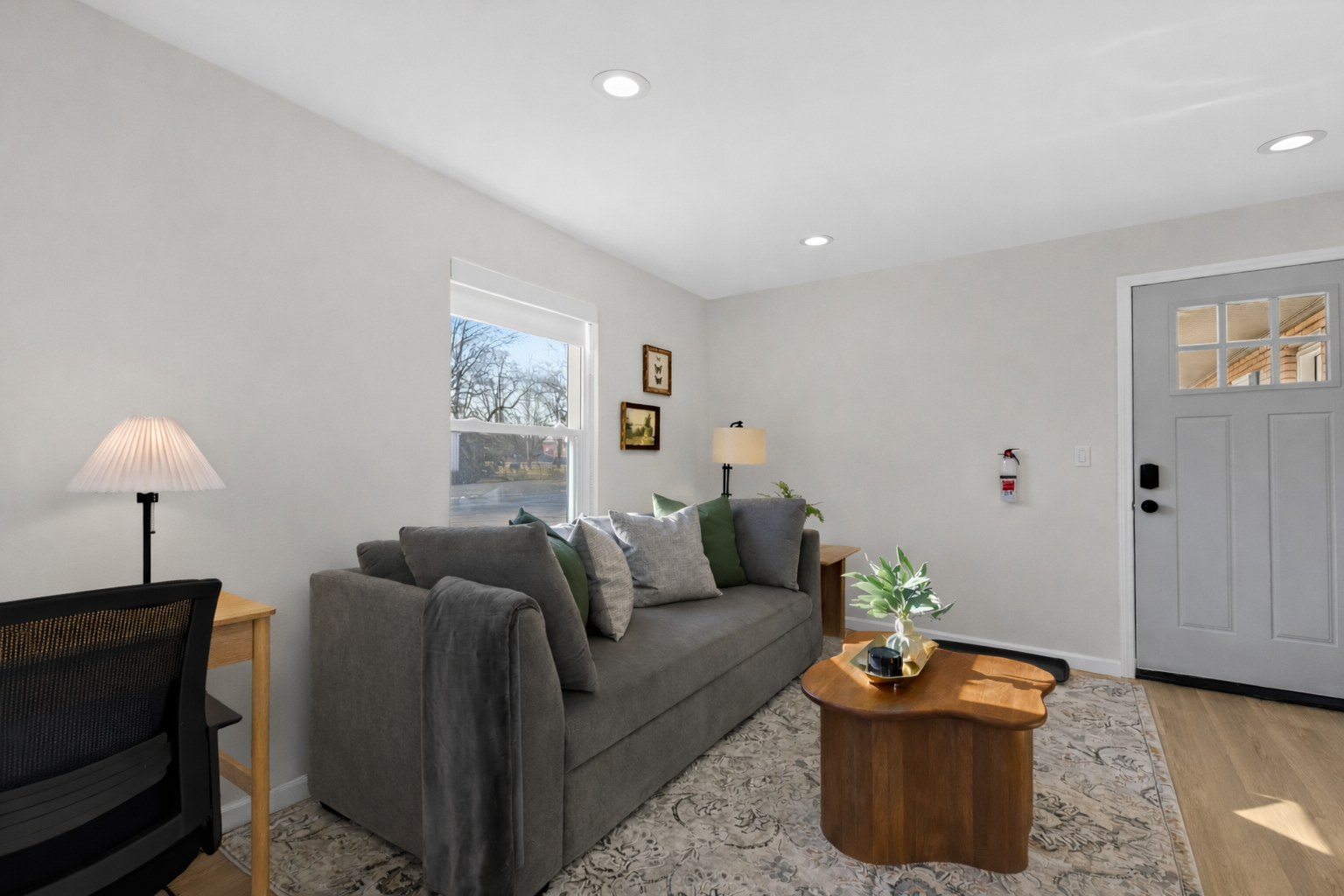 Comfortable living room with plush seating, soft natural light, and warm finishes—an inviting space to unwind or enjoy a cozy night in.