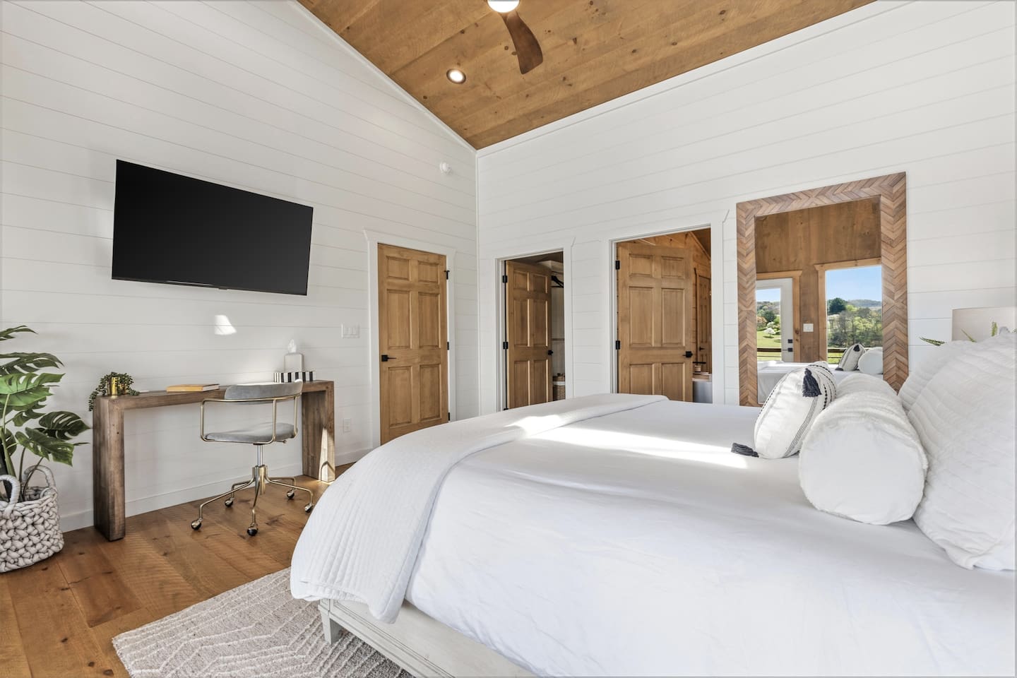 Spacious and functional with a large 55" wall-mounted TV, dedicated workspace and ceiling fan for comfort. In the closet you will find a luggage rack, full size ironing board and box fan for white noise with plenty of storage space.