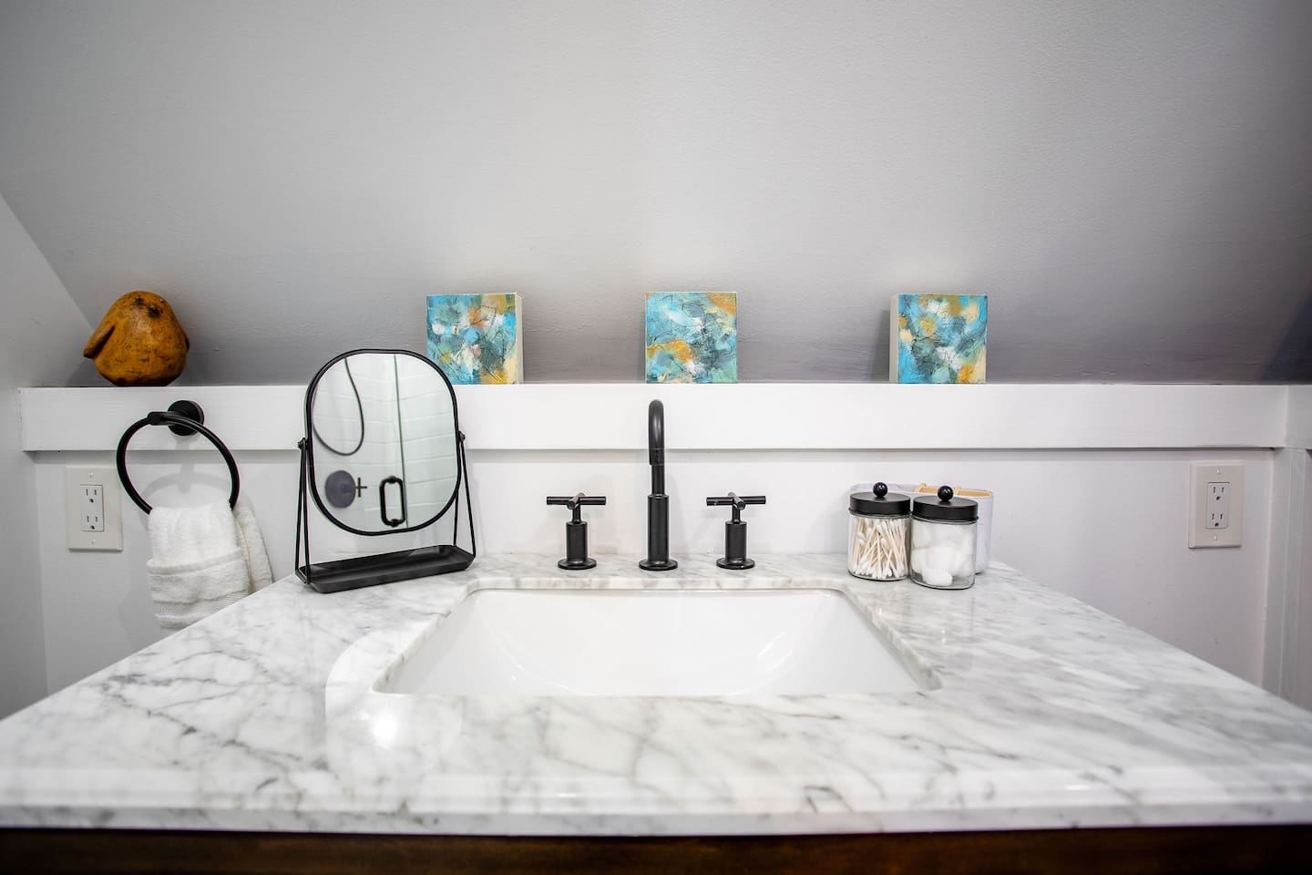 A bathroom sink paired with a small, simple mirror above it, creating a minimalist and functional space that’s both stylish and practical.