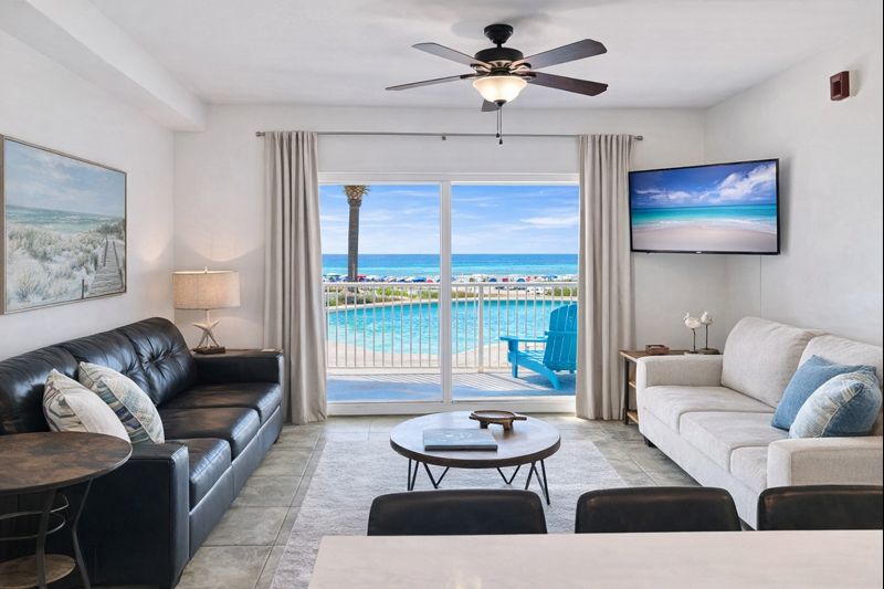 Living room with sleeper sofa, a 2nd sofa, smart TV, ceiling fan and balcony access