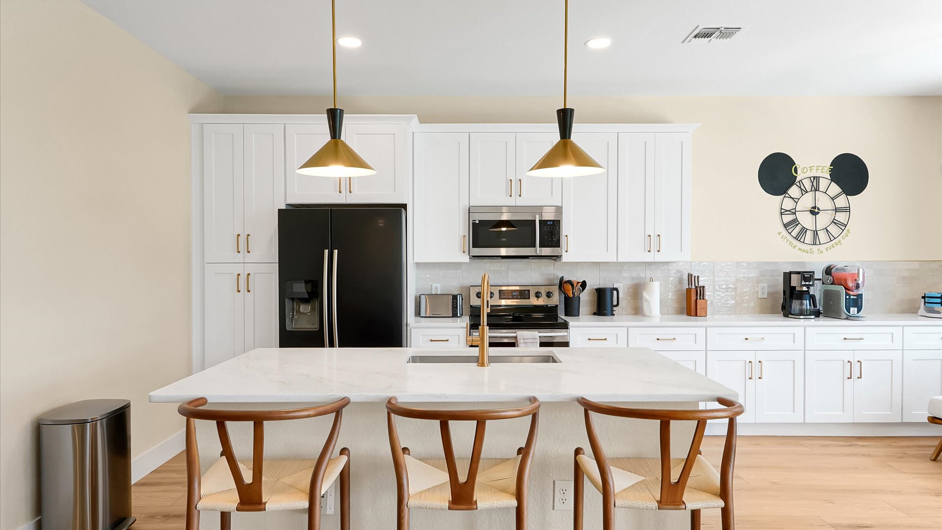 Kitchen: Fully renovated kitchen with generous storage, modern appliances and island seating for three.