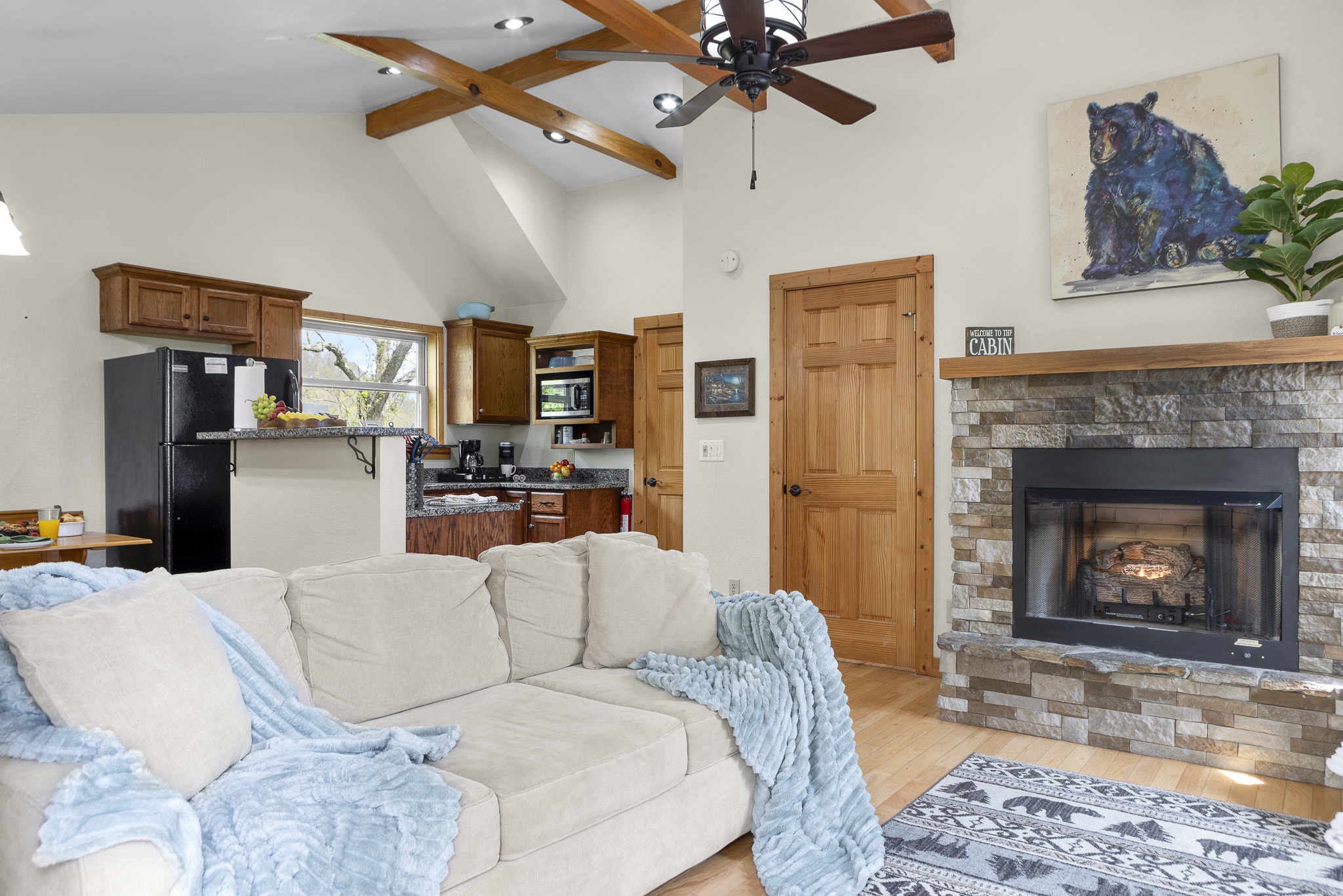 Living Room Retreat: Spacious area with comfy seating, a cozy fireplace, and rustic charm await you!