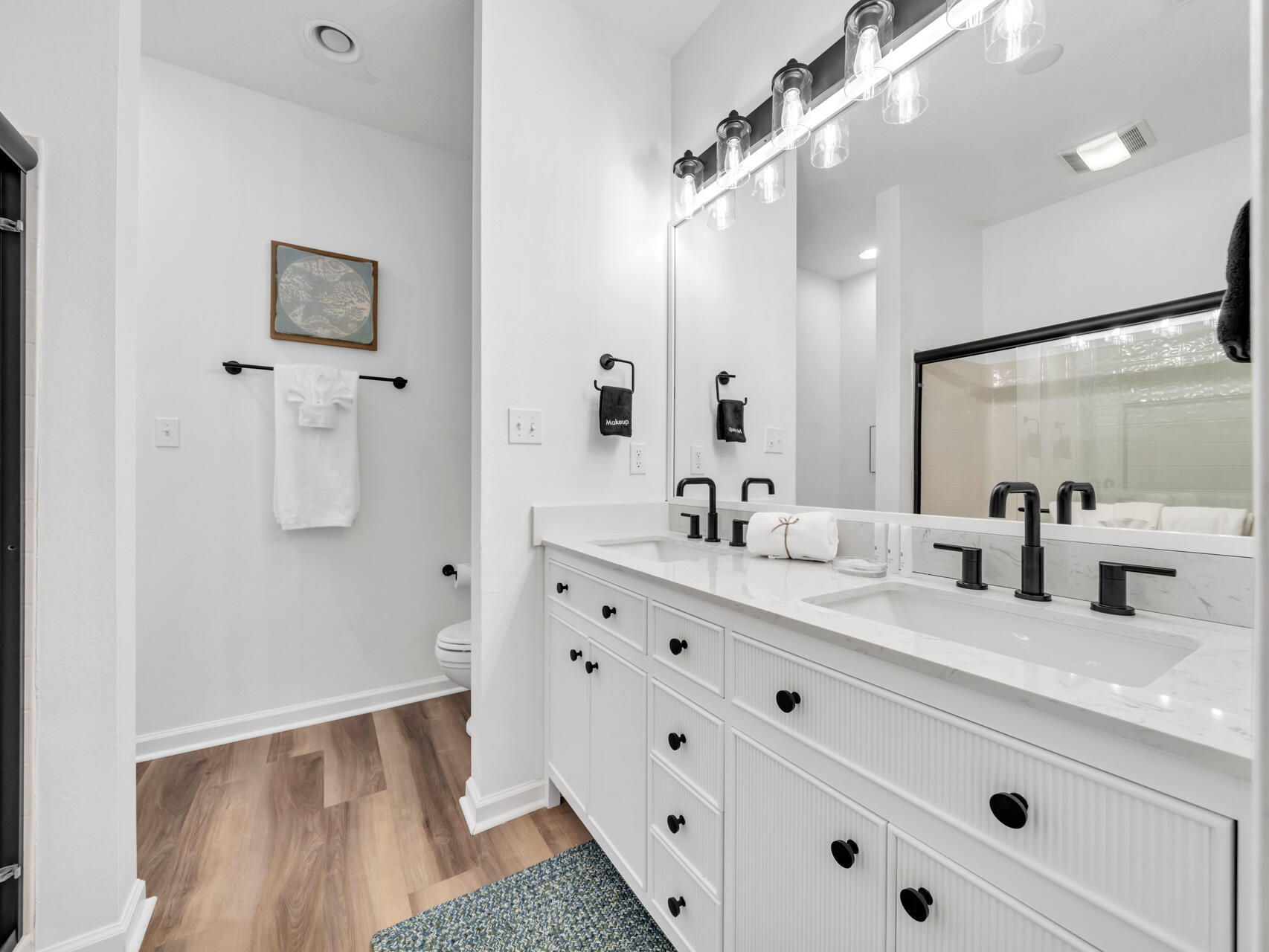 Dual sinks and ample storage in the downstairs primary bathroom