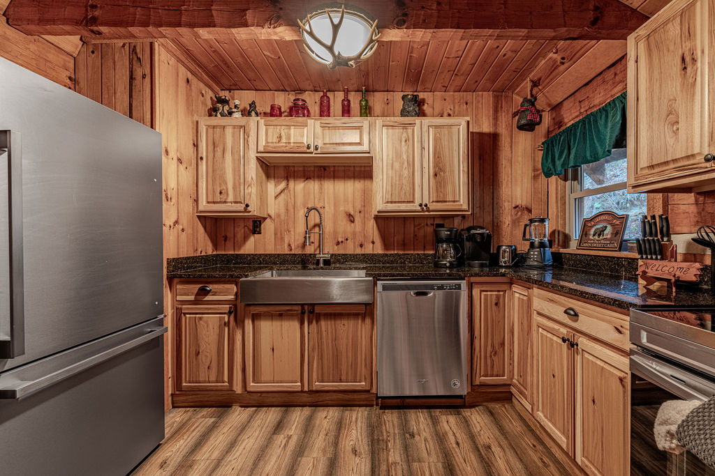 Kitchen with stove, fridge, and cabin cabinets