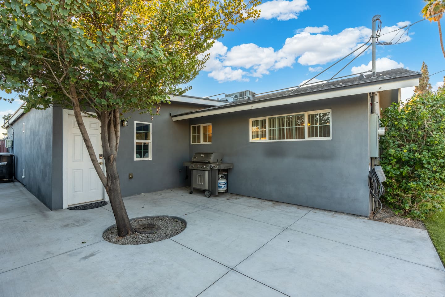 Inviting backyard featuring a griller, perfect for outdoor cooking and enjoying meals in a relaxed, open-air setting.
