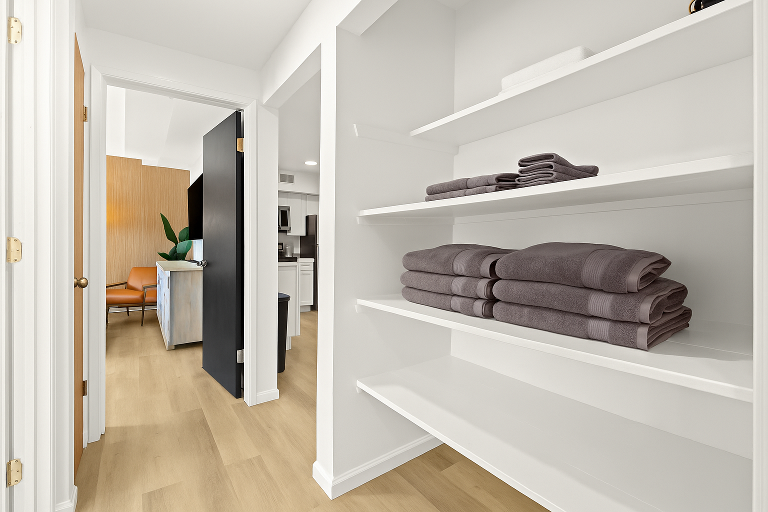 Fresh towels are fully stocked and easy to access from this convenient open-shelf linen nook.