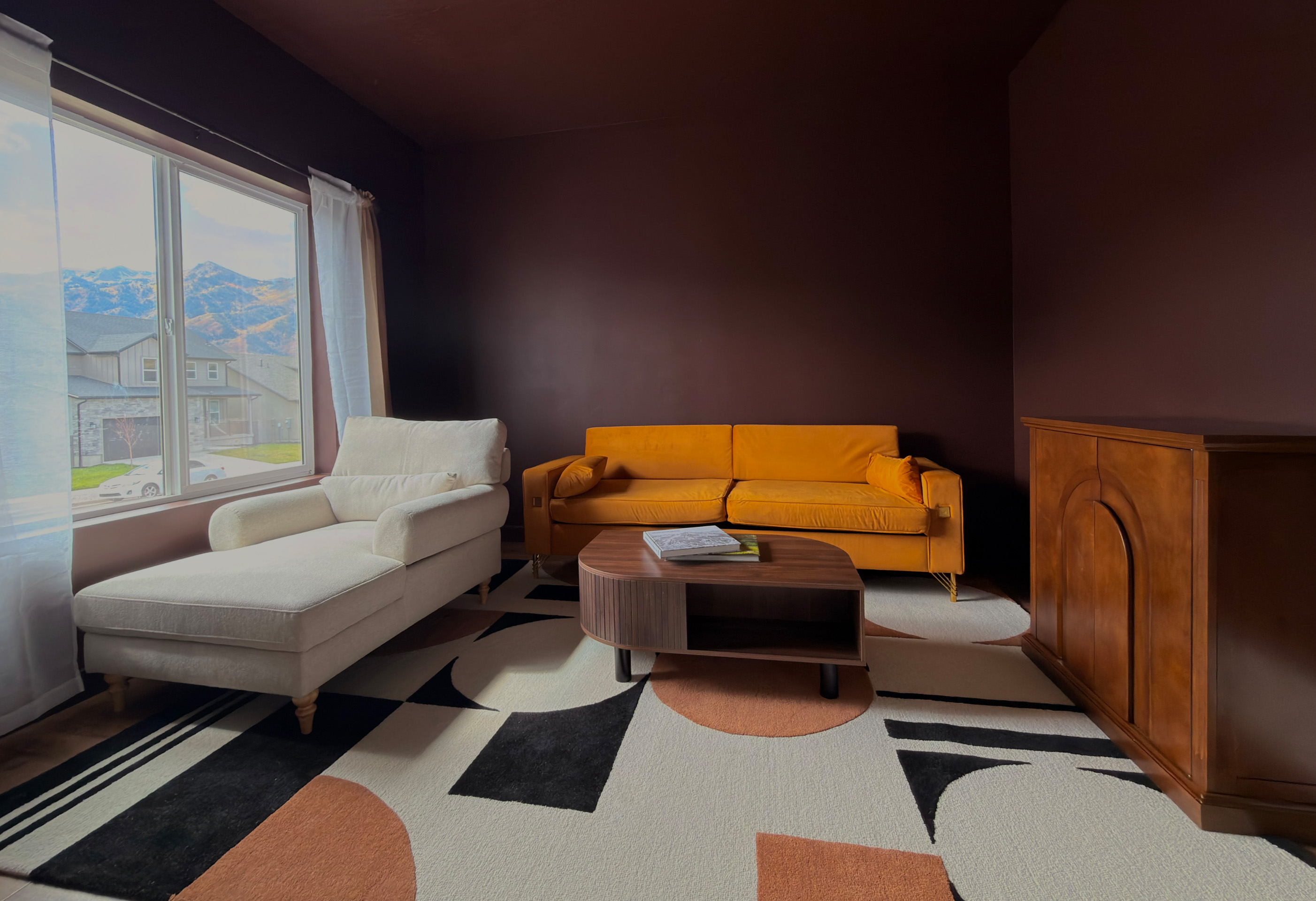 Chic, intimate den featuring plush seating and a rich color palette for relaxed conversation or quiet reflection.