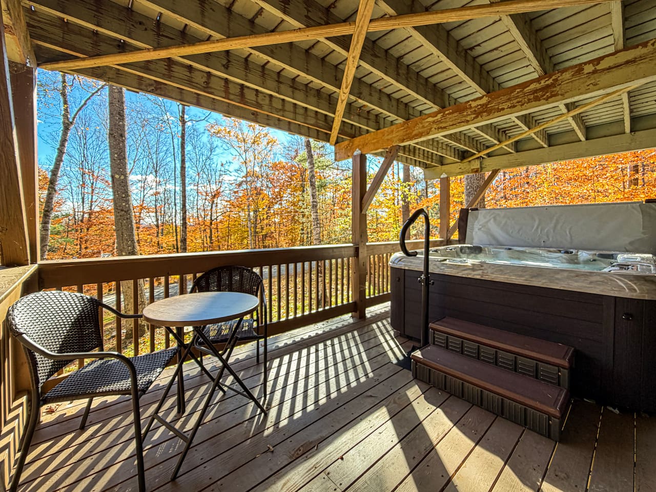 Lower deck with a hot tub and cafe table