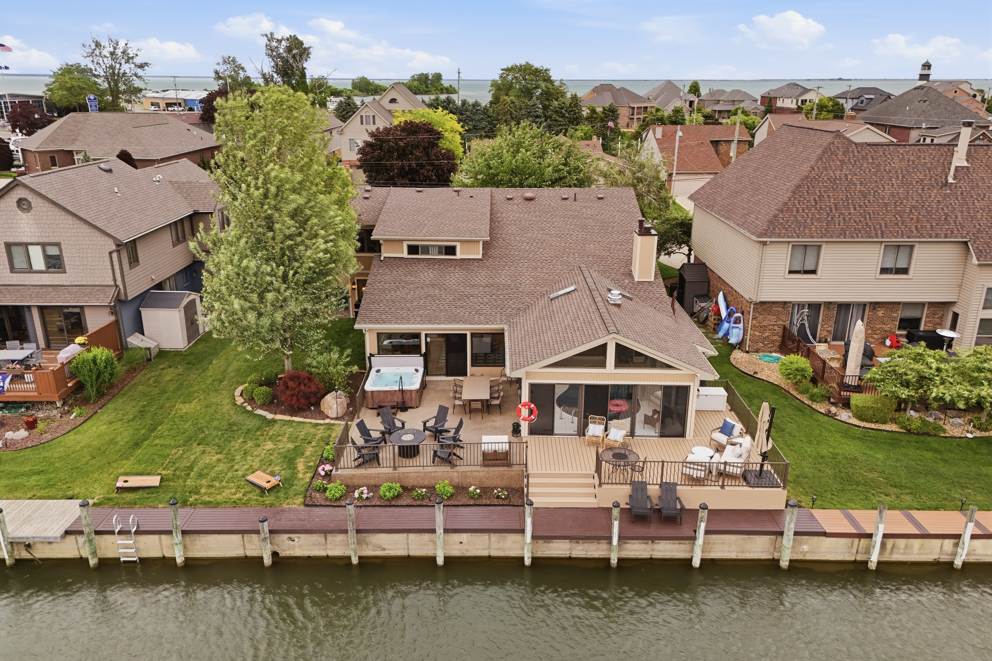 Waterfront home with a private canal-front deck, outdoor seating, and direct access to calm lake waters. Scenic and peaceful setting perfect for relaxing, entertaining, and enjoying true lakefront living.