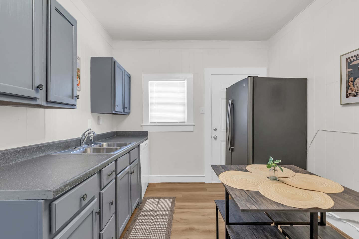 Open kitchen with island style seating and stainless steel appliances.