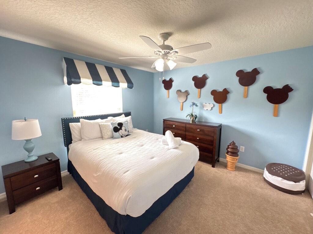 Queen bed Mickey Mouse themed room with adjoining bath