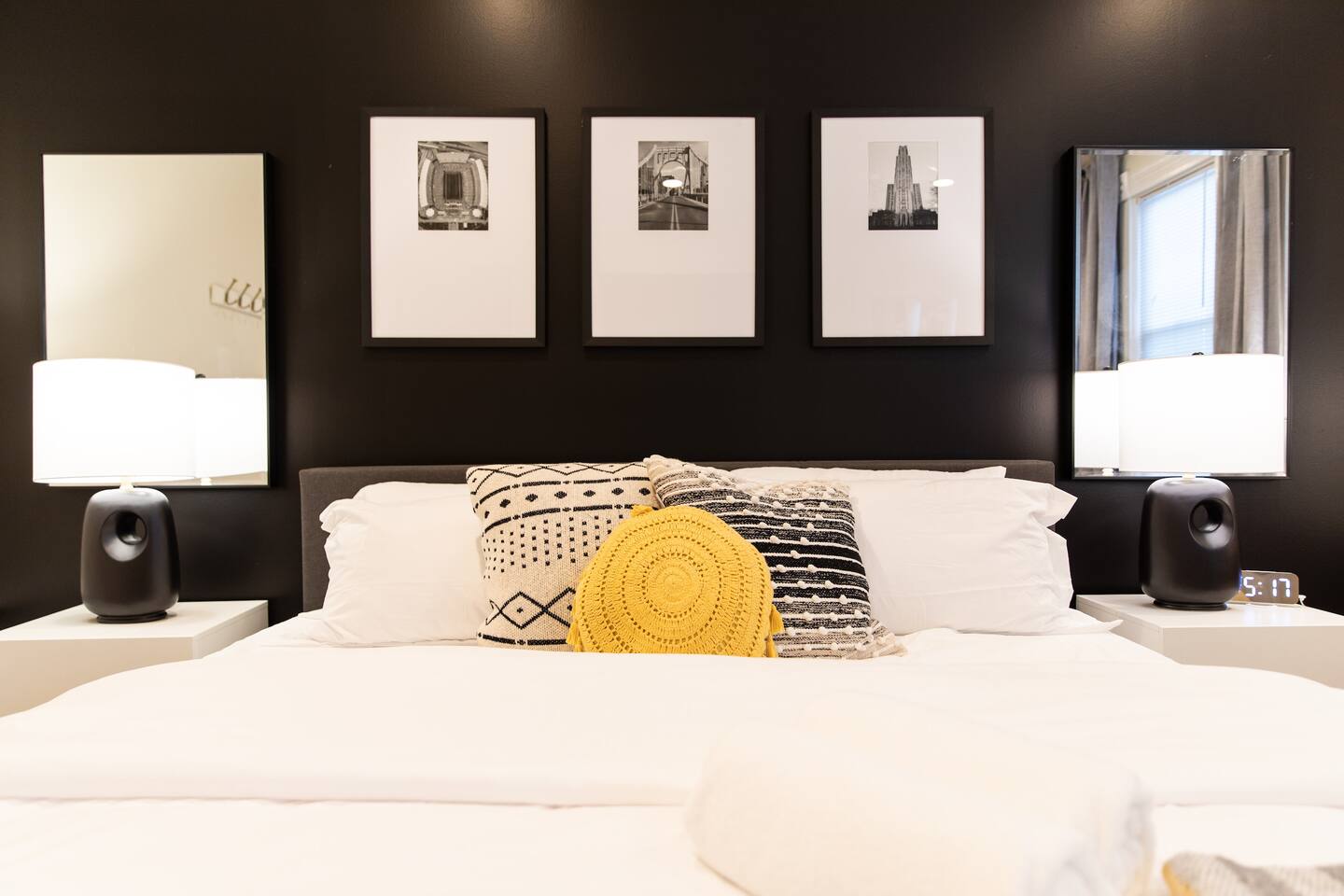 A cozy king-sized bed with soft, inviting linens, positioned beside a large window that lets in natural light, offering a peaceful and serene atmosphere.
