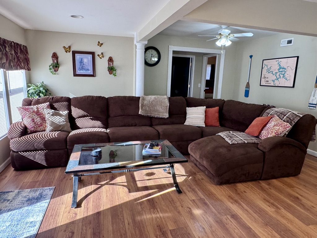Large sectional couch with a recliner on the end. The living room has all-new flooring as of March 2026.