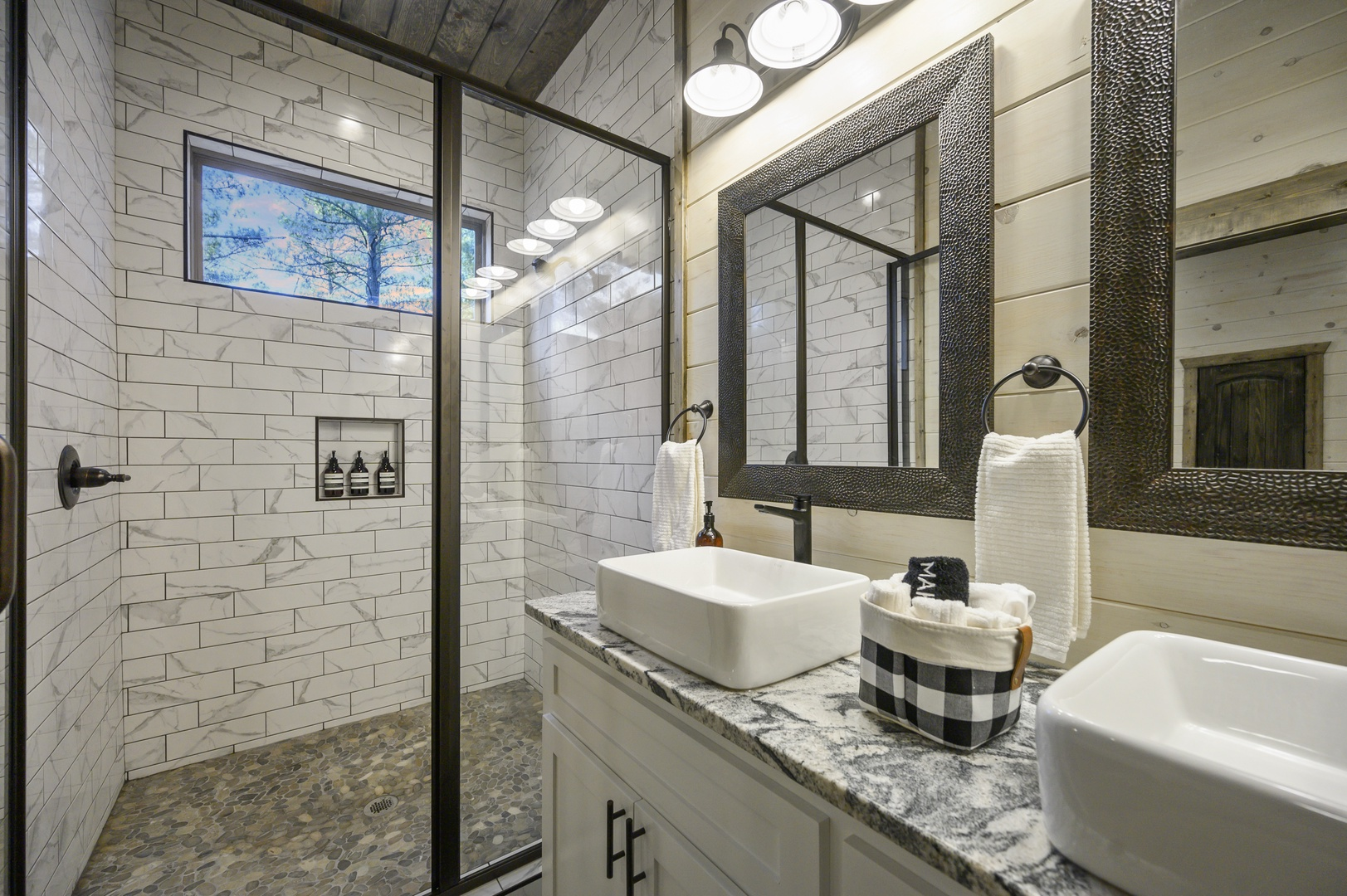 A bright, clean bathroom with double vanities and modern finishes — perfect for freshening up after a day of forest adventures.