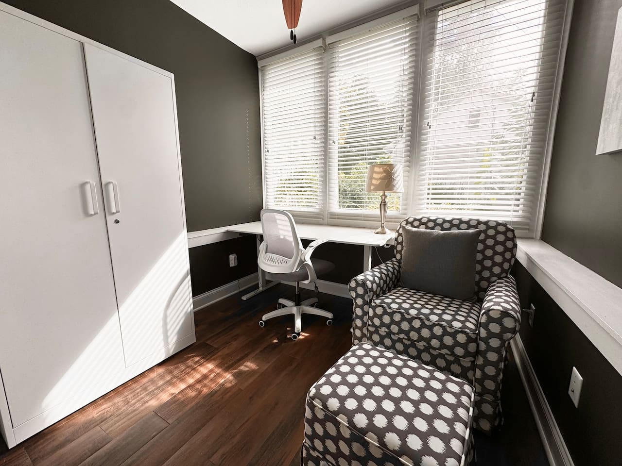 The sunny Garden Level Office includes an electric standing desk and rocking chair.