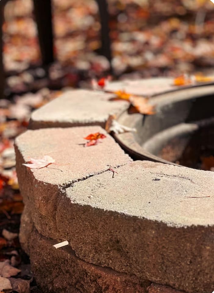 Cozy fire pit, with plastic chairs, perfect for relaxing evenings under the stars. Ample seating for everyone.