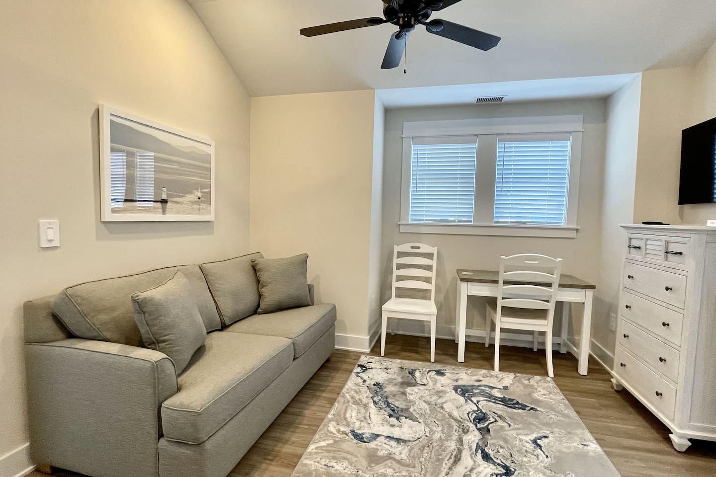 A quiet corner to get some work done. The den features a desk, two chairs, and a dresser for added storage
