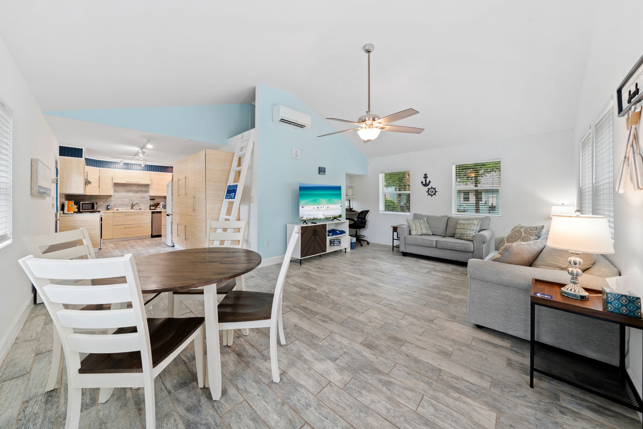 Open-concept living and dining area with a vaulted ceiling