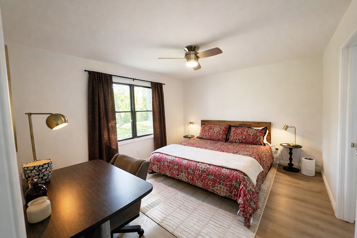 A warm, richly-decorated bedroom with layered textiles for a cozy night's sleep.