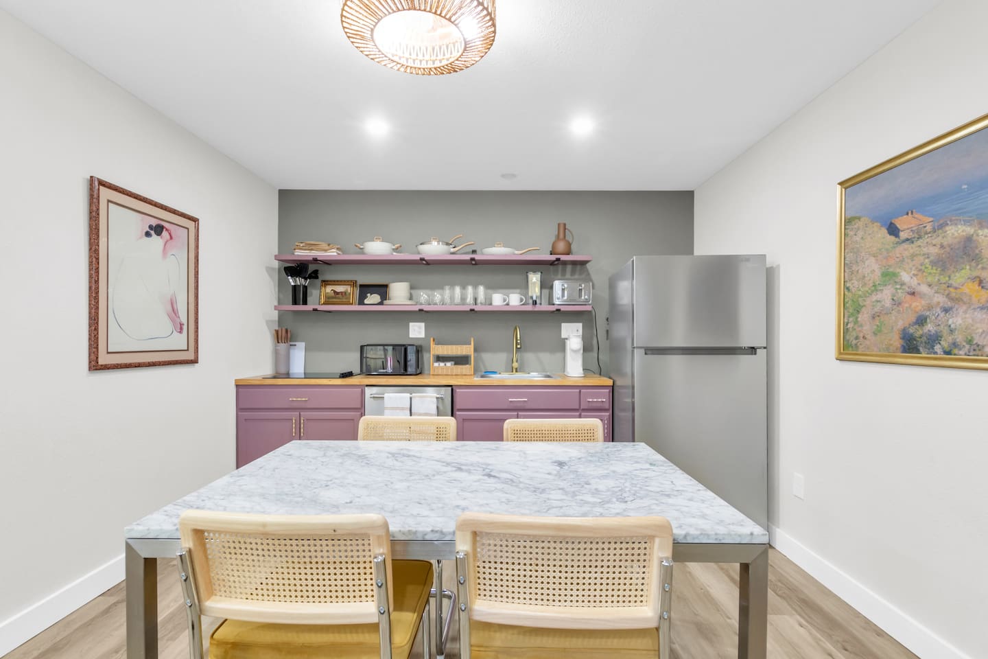 Bright, fashionable kitchen and dining space for four guests, featuring a fully equipped setup and inviting design for every occasion.
