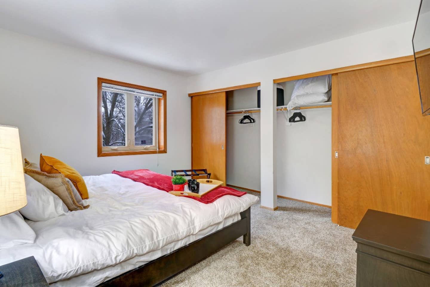 Blackout curtains, though not pictured are on the bedroom window. Luggage rack and velvet hangers in ample bedroom closet space.