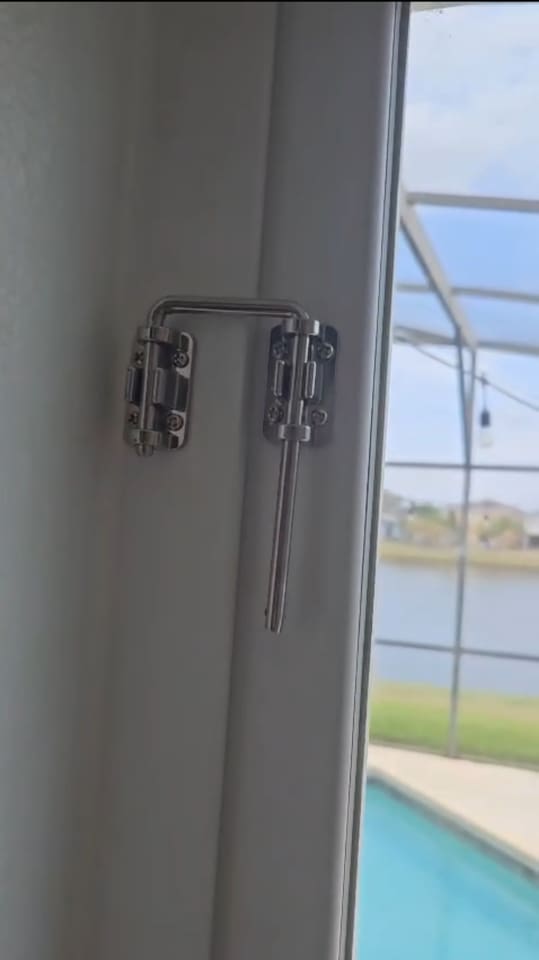 SAFETY FEATURE - Additional security lock installed at about 6ft high for sliding door leading to patio and pool. 