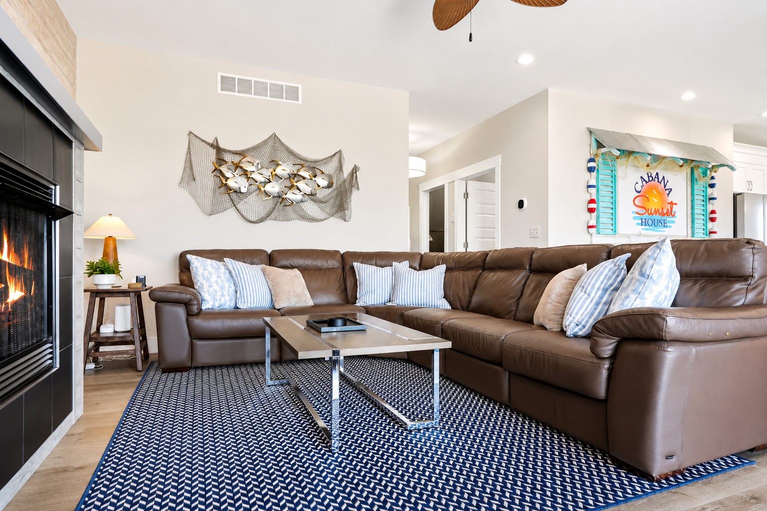 Kick back and unwind in the spacious living room, featuring plush sectional seating, coastal-inspired décor, and a cozy atmosphere perfect for movie nights or relaxing after a day on the water.
