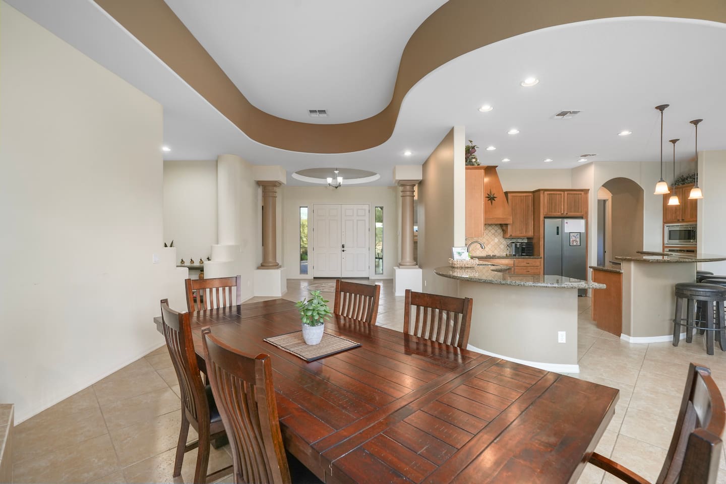 Open dining space connecting the kitchen, living area, and entryway