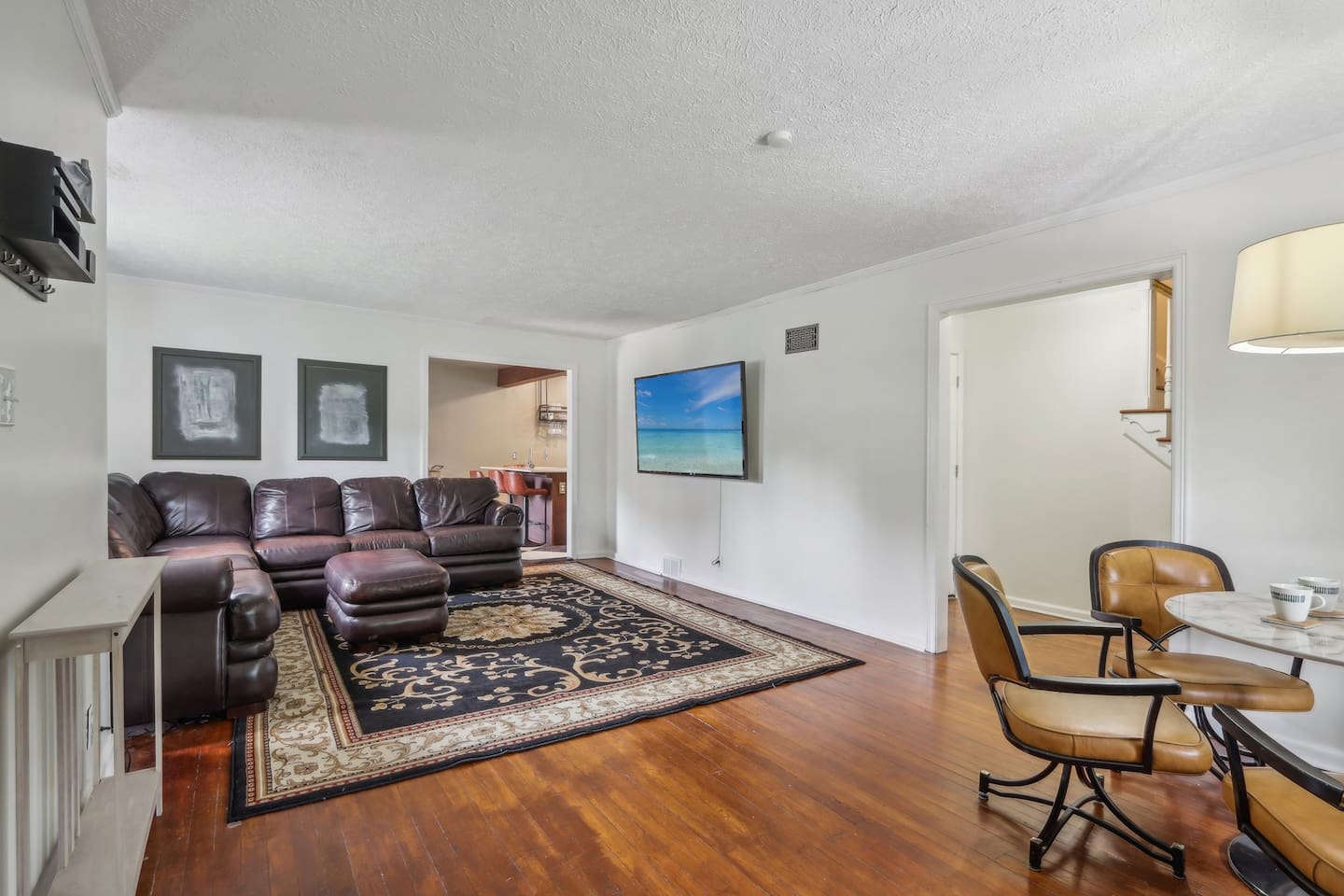 Kick back for a movie night or conversation in this inviting living room, complete with comfortable seating and a cozy area rug.