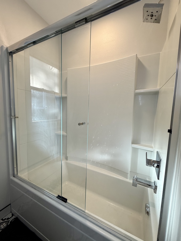 Full bathroom at the end of the hallway with an updated medicine cabinet/mirror, new elongated oval toilet, and tub/shower combo.
