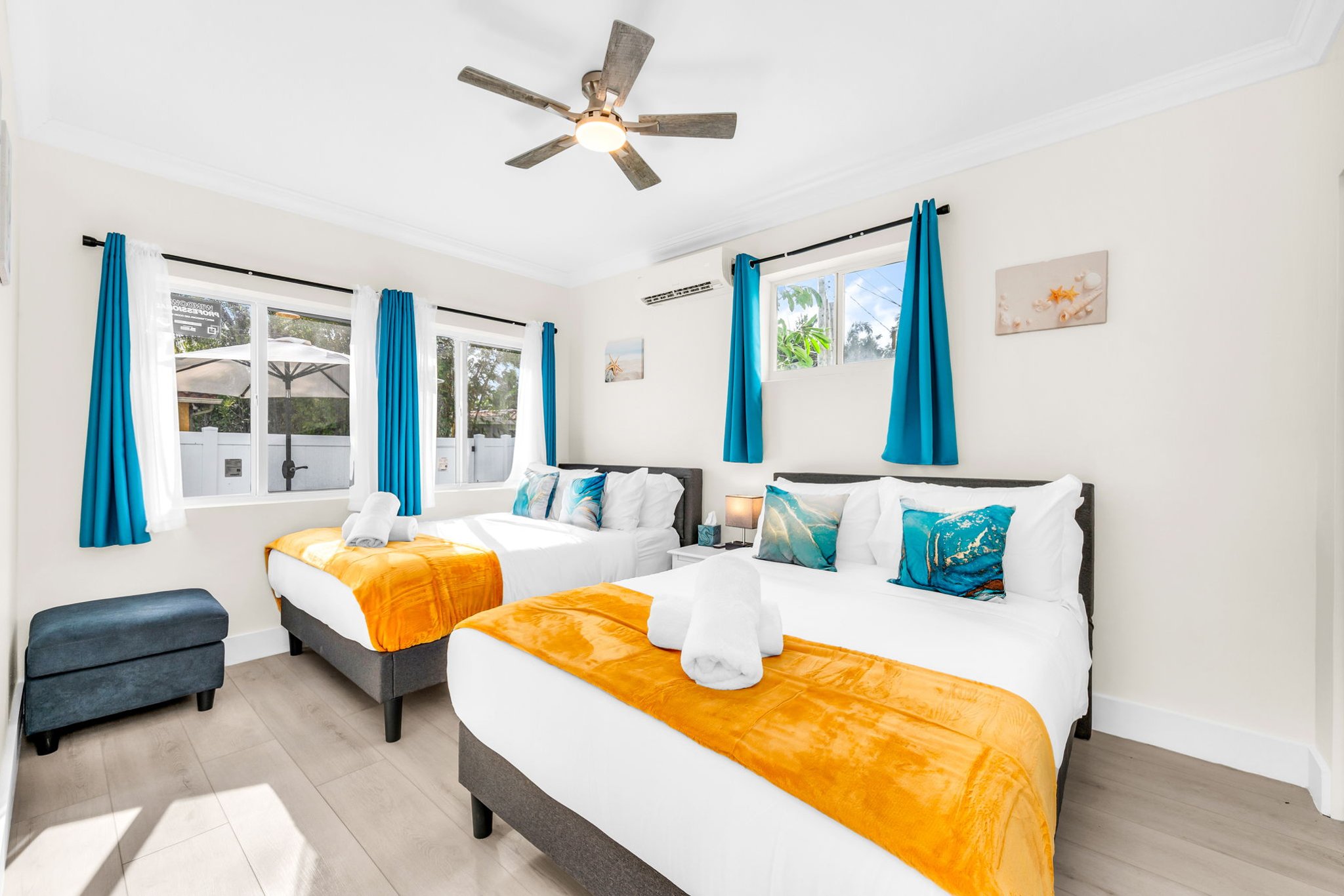 Relax in the sunny 4th bedroom—complete with two full-size beds, coastal décor, and a freshly updated ensuite bathroom.
