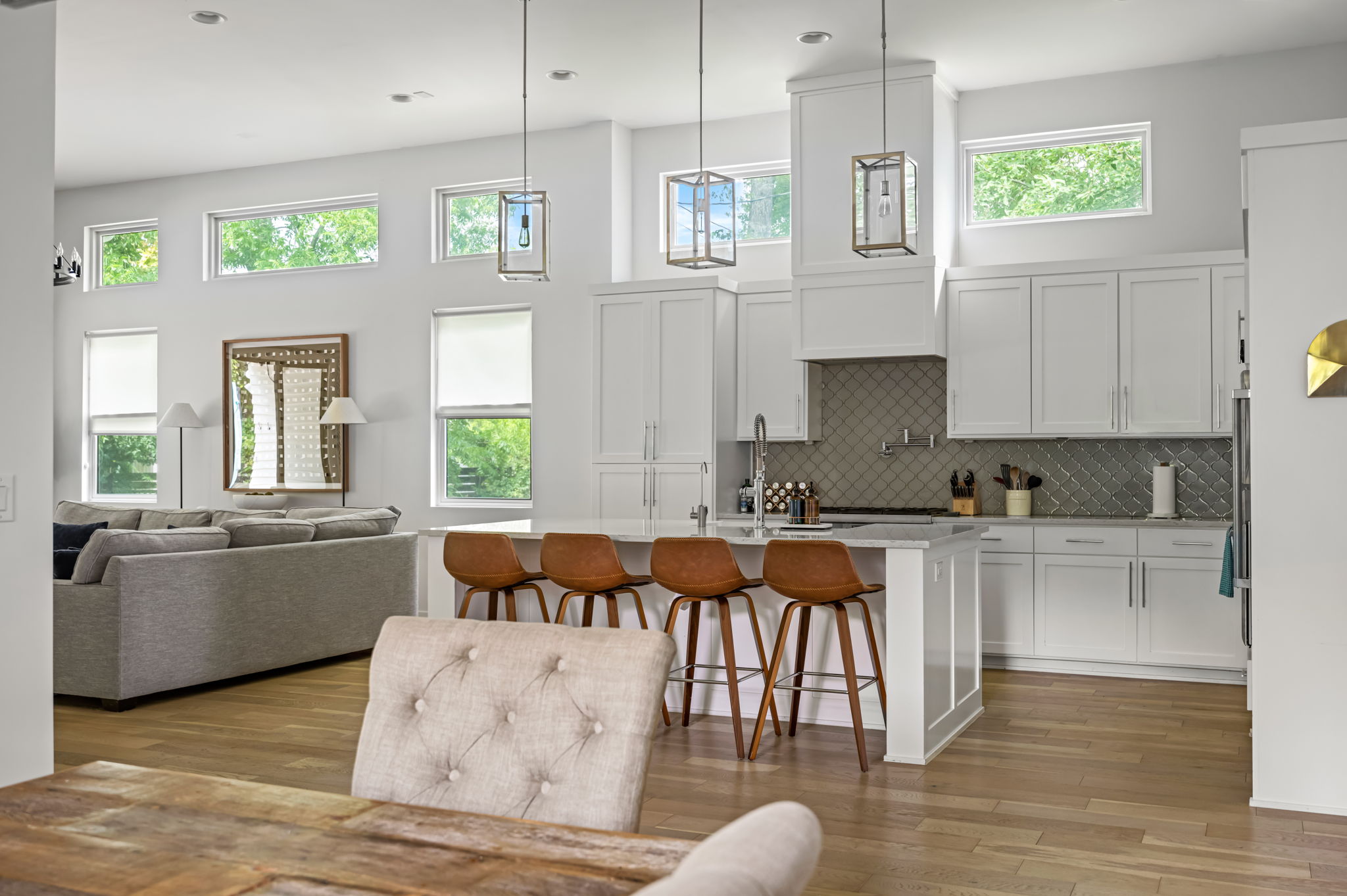 Spacious kitchen island with bar seating overlooking a cozy living room — the perfect hub for gathering while staying connected.