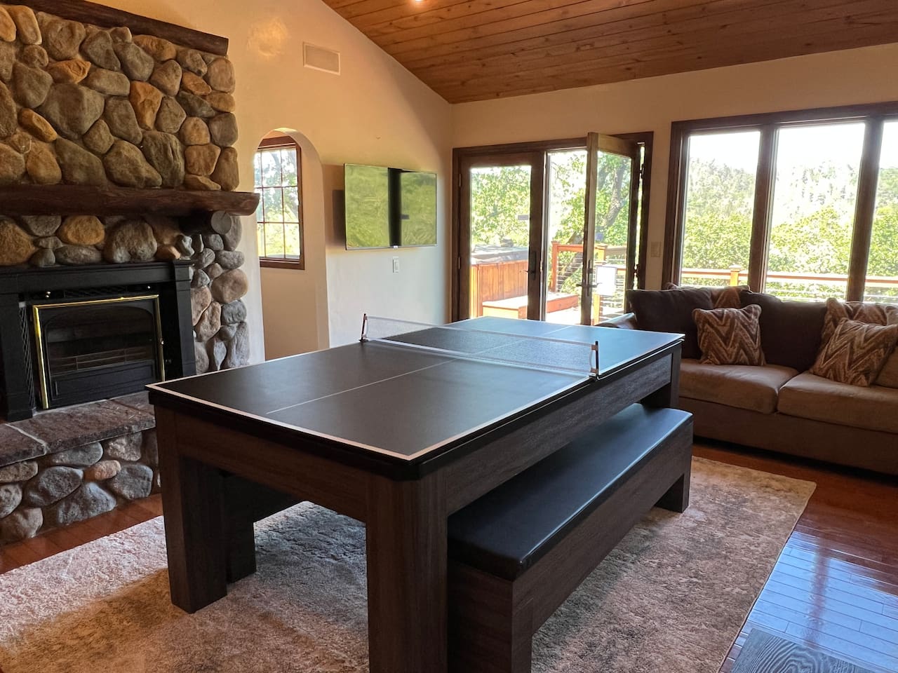 Second Living Room with a pool table, ping pong table topper, fireplace, surround speaker system, 4K TV, fireplace, and access to the back deck.