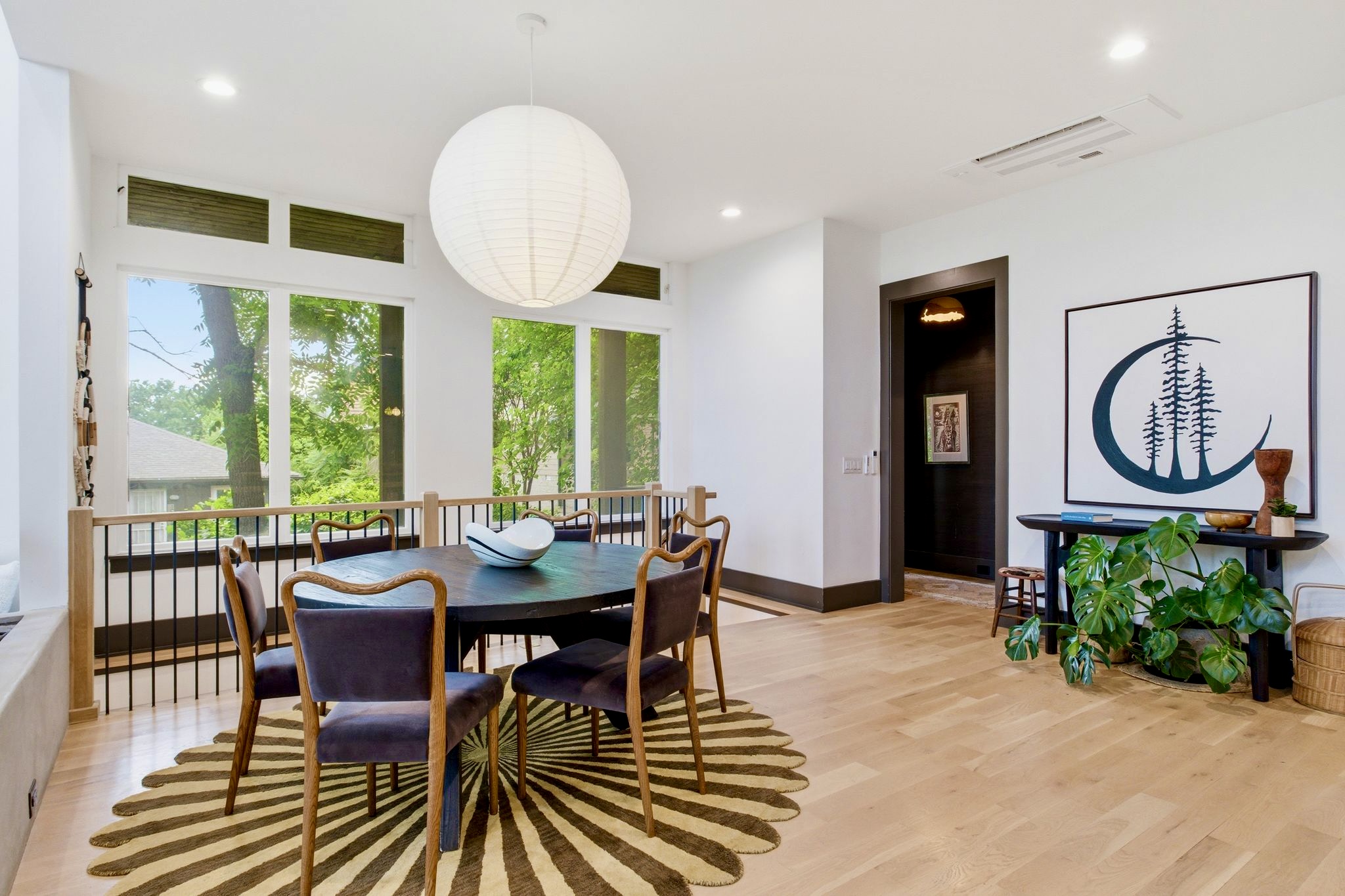 Casual dining nook w/ a round table, pendant light & a relaxed, welcoming vibe.
