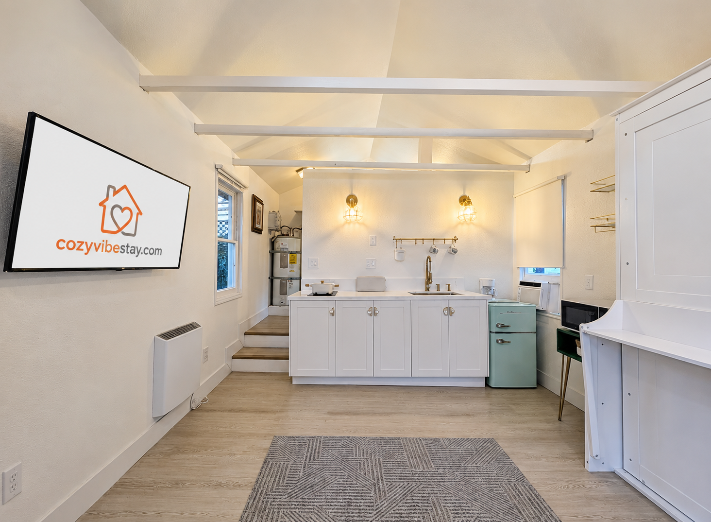 Open-concept studio with kitchenette and Smart TV.