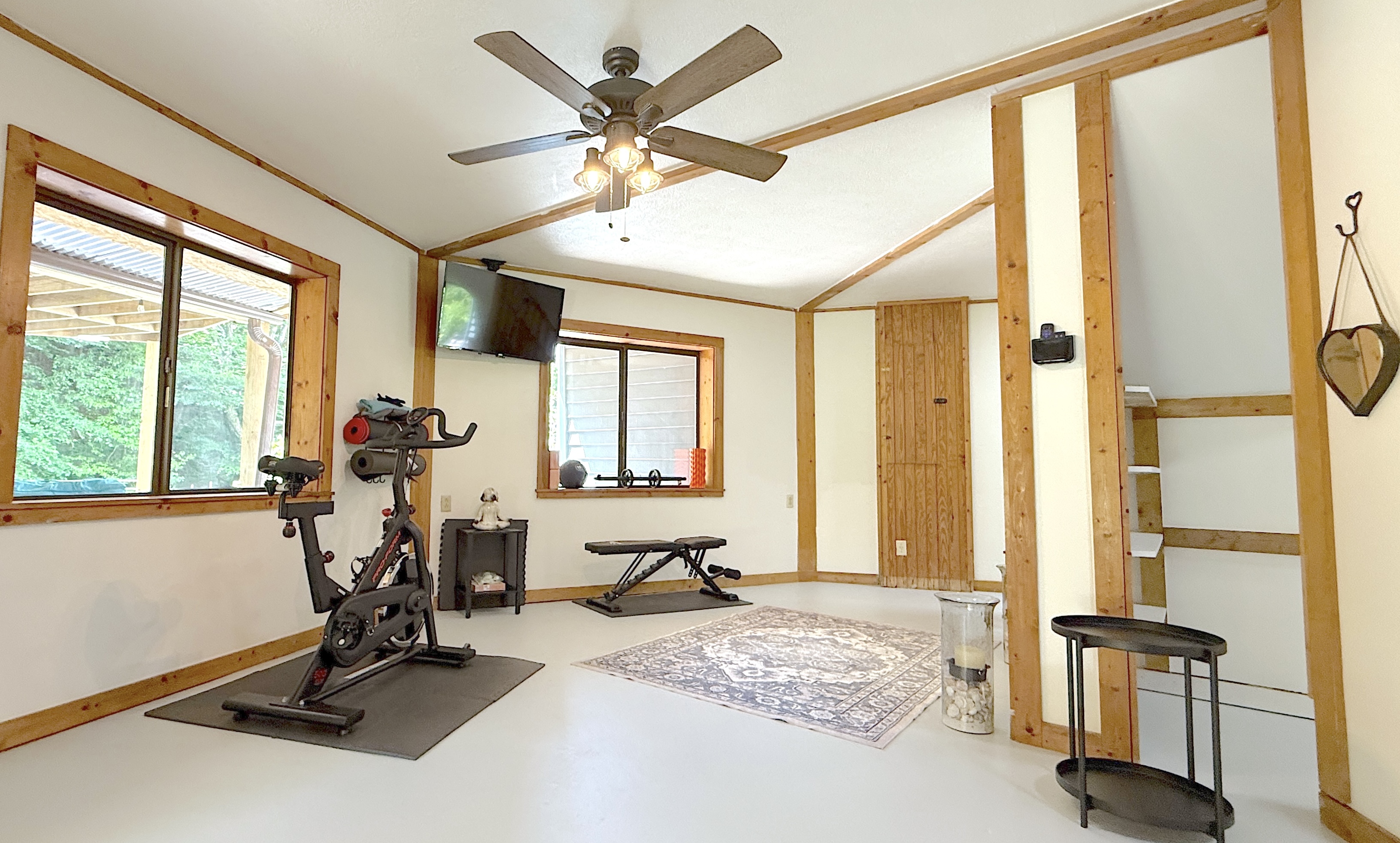 Exercise bike, bench, yoga items and weights