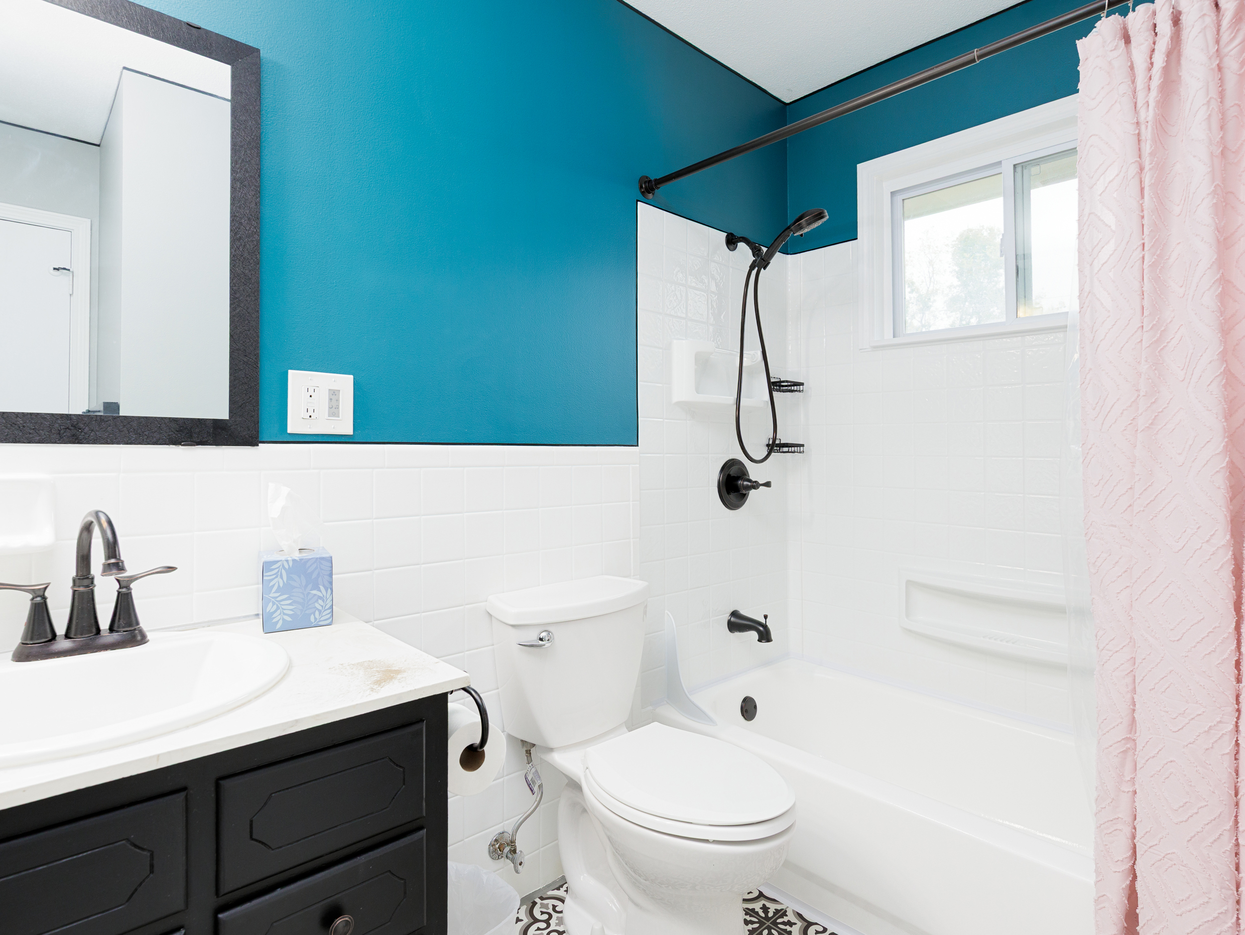 Main floor bathroom featuring a shower and clean, modern fixtures.