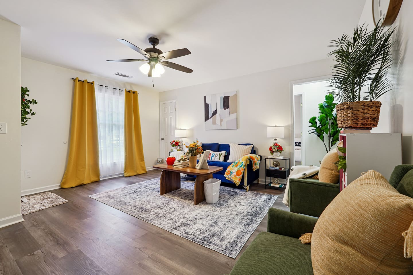 The living room features cozy furniture, including a comfortable blue couch, and an Amazon Fire-powered Smart TV for your entertainment. You’ll also find the Xfinity modem conveniently located here, convenient for ethernet connection.